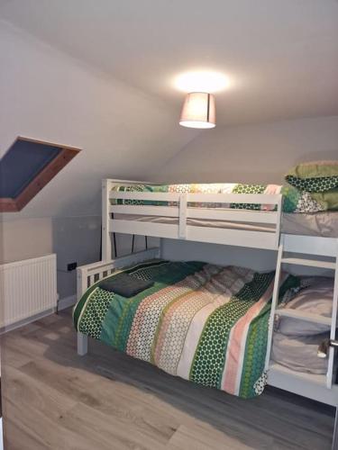 a room with two bunk beds in a room at The Holiday House - Portstewart in Portstewart