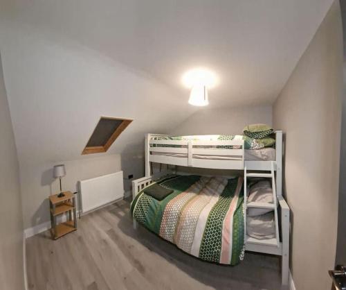 a bedroom with a bunk bed in a room at The Holiday House - Portstewart in Portstewart