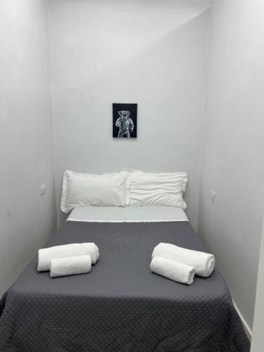 a bedroom with a bed with two towels on it at La Casa di Manila in Naples