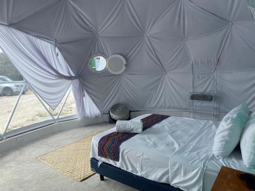 a bedroom with a bed in a tent at Hidden Island Glamping Isla Mujeres in Isla Mujeres