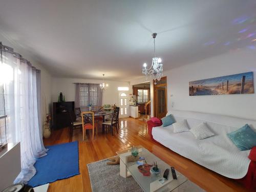 a living room with a white couch and a table at Madeira Island Villa Oceane Ribeira Brava in Ribeira Brava