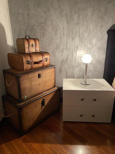 a stack of suitcases stacked on top of a dresser at LA CASA DI AMBRA in Limbiate