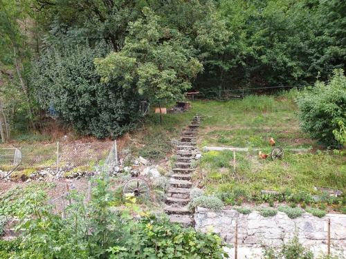 a set of stairs in a field with trees at L'appart - Couvet in Couvet