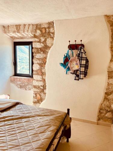 a bedroom with a bed and a stone wall at Torretta Margiotta in Picinisco