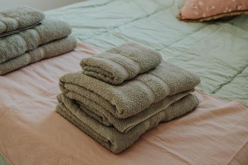 a pile of towels sitting on top of a bed at Hol Gok Patagonia in Esquel