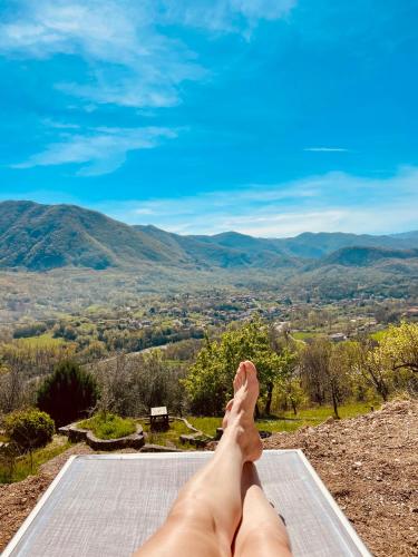 a person laying on a mat with their feet up on a mountain at Torretta Margiotta in Picinisco