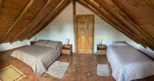 a bedroom with two beds in a attic at Casa Semilla in Cotacachi