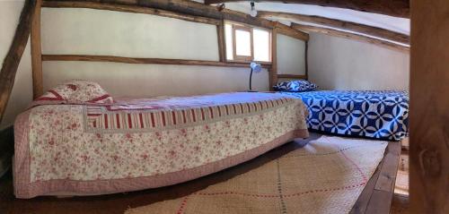 a bedroom with two beds and a window at Casa Semilla in Cotacachi
