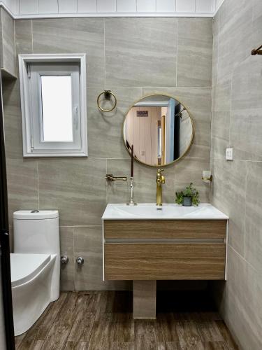 a bathroom with a sink and a mirror at Curiñanco Casa Playa in Curiñanco