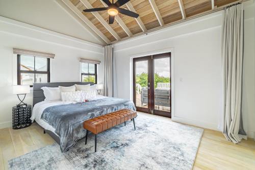 a bedroom with a bed and a ceiling fan at Casa Serena + The Pool Club @ Mahogany Bay in San Pedro