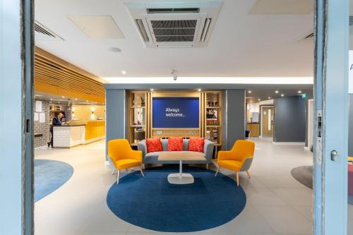 a lobby of a store with a couch and chairs at Holiday Inn Express London Croydon by IHG in Croydon