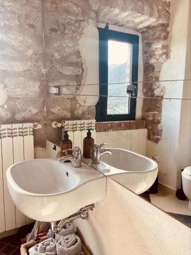 a bathroom with a sink and a mirror at Torretta Margiotta in Picinisco