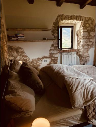 a bedroom with a bed and a window in it at Torretta Margiotta in Picinisco