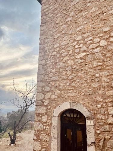 a tall stone building with a door in it at Torretta Margiotta in Picinisco