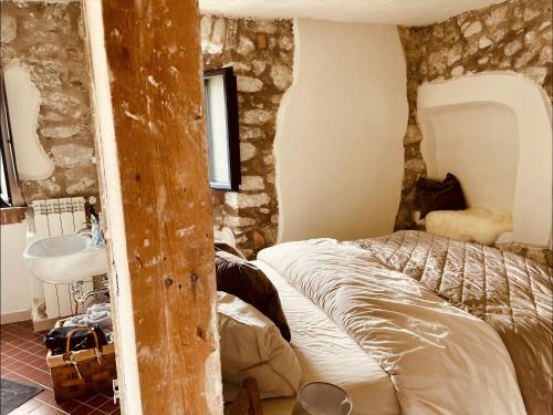 a bedroom with a bed and a sink at Torretta Margiotta in Picinisco