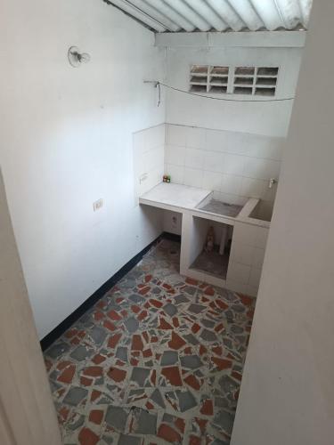 an empty bathroom with a tile floor and a table at El descanso in Garzón