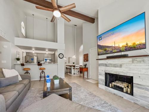 a living room with a fireplace and a large tv at Lemon Tree #72 Chandler condo in Chandler