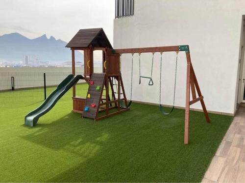 a playground with a slide and a swing at Estilo y Comodidad en Monterrey in Monterrey