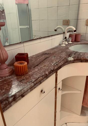 a bathroom counter with two sinks and a mirror at Villa Liuba con piscina in Forio d'Ischia