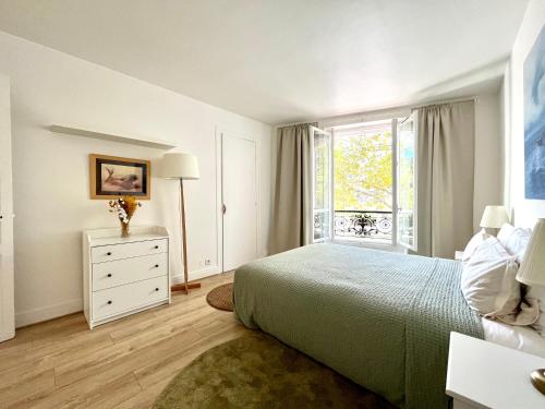 une chambre blanche avec un lit et une fenêtre dans l'établissement Très bel appartement 3 pièces à Paris Centre, à Paris