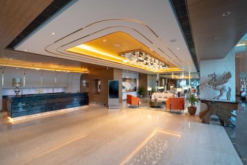 a lobby of a hotel with a bar and a couch at Radisson Blu Pune Hinjawadi in Pune