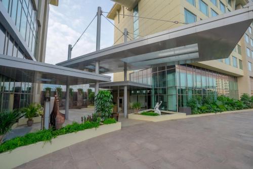 a large building with a courtyard with plants at Radisson Blu Pune Hinjawadi in Pune