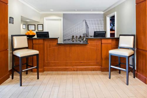 two chairs sitting at a bar in a waiting room at Staybridge Suites - Charlotte Ballantyne by IHG in Charlotte