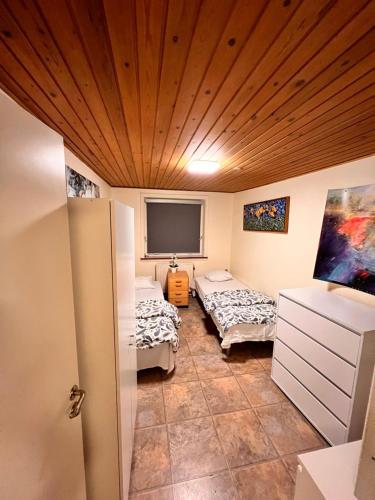a room with two beds and a flat screen tv at HBA Appartments Rodovre in Rødovre