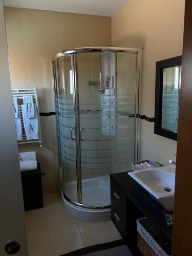 a bathroom with a shower and a sink at Maria Vagueira BeachHouse in Vagos