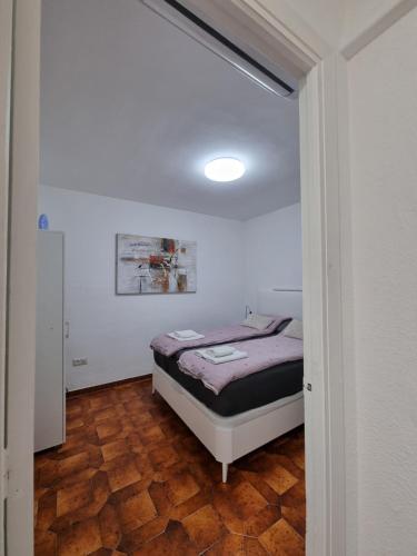 ein Schlafzimmer mit einem Bett in einem weißen Raum in der Unterkunft Comfortable one bedroom apartment in Fuengirola