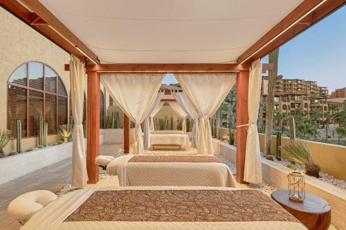 a bedroom with two beds on a balcony at Grand Fiesta Americana Los Cabos All Inclusive Golf & Spa in Cabo San Lucas