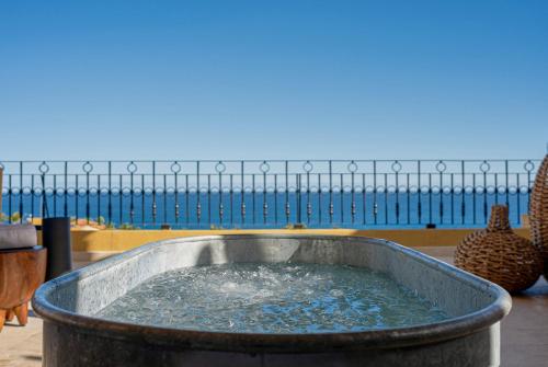 a large tub filled with water in front of the ocean at Grand Fiesta Americana Los Cabos All Inclusive Golf & Spa in Cabo San Lucas