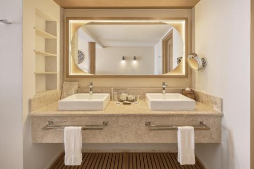 a bathroom with two sinks and a large mirror at Grand Fiesta Americana Los Cabos All Inclusive Golf & Spa in Cabo San Lucas