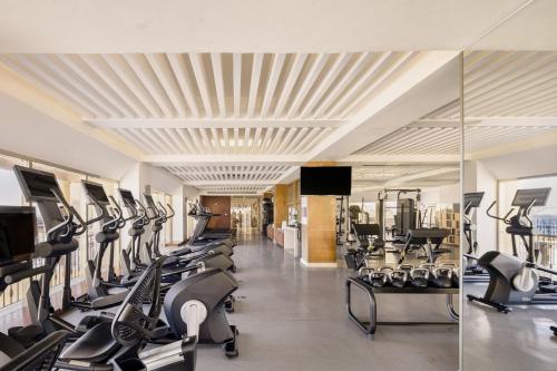 a gym with a lot of treadmills and ellipticals at Grand Fiesta Americana Los Cabos All Inclusive Golf & Spa in Cabo San Lucas