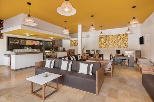 a living room with a couch and a table at Grand Fiesta Americana Los Cabos All Inclusive Golf & Spa in Cabo San Lucas
