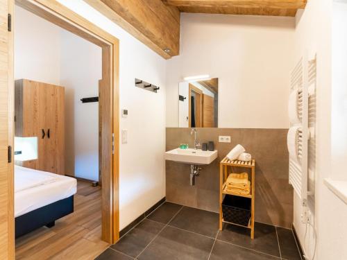 a small bathroom with a sink and a mirror at Chalet Degens in Krimml