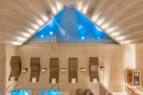 a swimming pool with a large window above it at Grand Fiesta Americana Los Cabos All Inclusive Golf & Spa in Cabo San Lucas