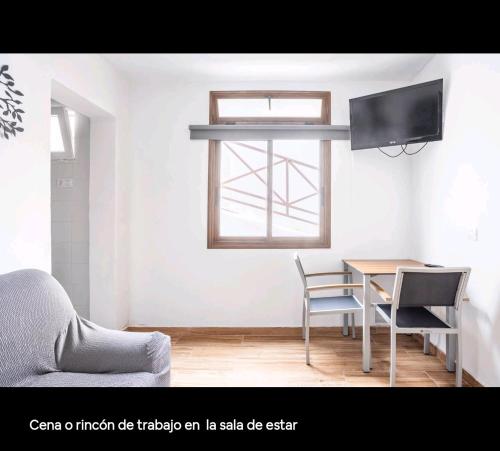 a living room with a table and a tv at Apartamento Picar in Santa Cruz de Tenerife