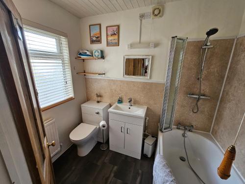 une salle de bain avec toilettes, douche et lavabo dans l'établissement Carrstone Cottage, à Heacham