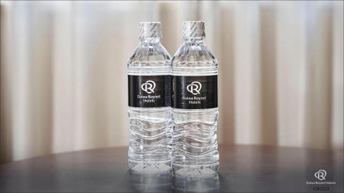 a bottle of water sitting on top of a table at Daiwa Roynet Hotel Hachinohe in Hachinohe