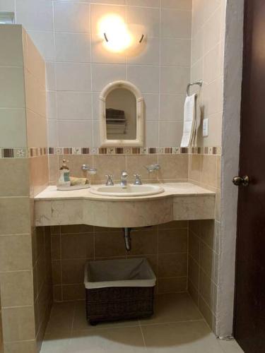 a bathroom with a sink and a mirror at Nice and well located apartment in Santa Fe in Caucel