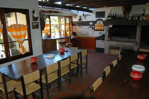a kitchen with a large wooden table and chairs at Hosteria Querandi in Villa Gesell
