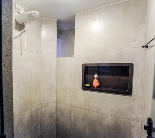 a bathroom with a shower with a bottle in a window at Casa da Nivea in São Paulo