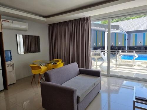 a living room with a couch and a table at Chequers Suites Subic Bay in Olongapo