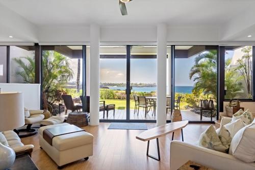 an open living room with a view of the ocean at Mauna Lani Point in Waikoloa