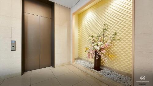 a lobby with a vase of flowers in a hallway at Daiwa Roynet Hotel Hachinohe in Hachinohe