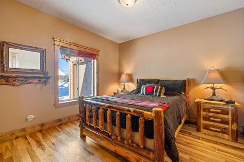 a bedroom with a wooden bed and a window at New! Black Bear Inn - Pet friendly - trailer parking - walk to lake - rustic in Donnelly