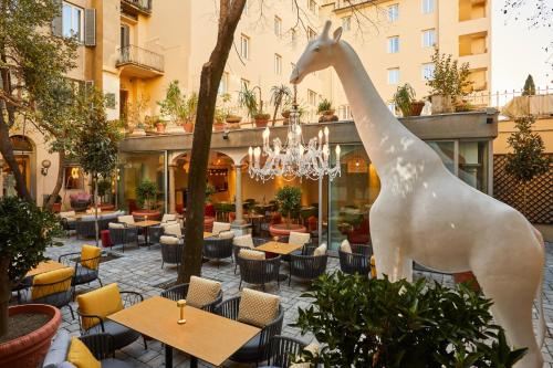 a statue of a giraffe in front of a restaurant at Hotel Indigo Florence, an IHG Hotel in Florence