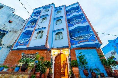 a blue and white building with a doorway at Dar Jinane in Chefchaouene
