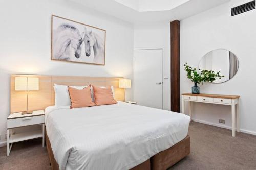 a bedroom with a large bed with two tables and two lamps at Inner City Retreat 1BD Pyrmont - 302 in Sydney